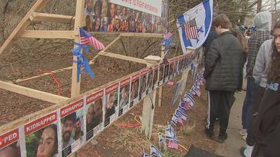 Hundreds attend ceremony in Newton to rededicate a vandalized display for hostages taken by Hamas