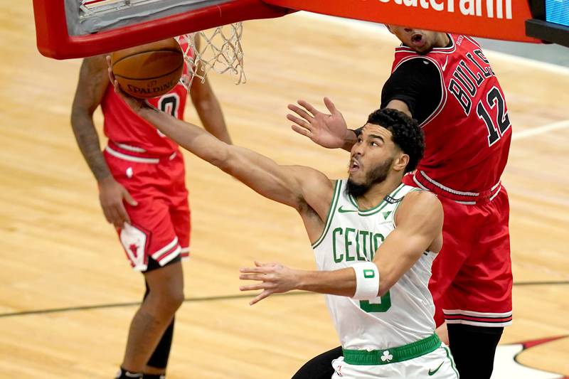 Jayson Tatum scores on a reverse layup during the first half of an NBA basketball game against the Chicago Bulls, Monday, Jan. 25, 2021, in Chicago.