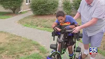 Boy with cerebral palsy walks at graduation months after taking first steps with robotic walker