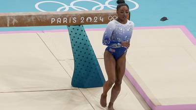 Simone Biles slips off the balance beam