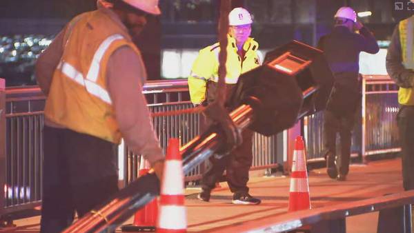 Woman hospitalized after being struck by falling light post on Boston bridge