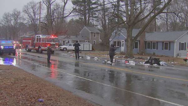 Woman hospitalized, road left littered with trash after BMW slams into house in Hanson
