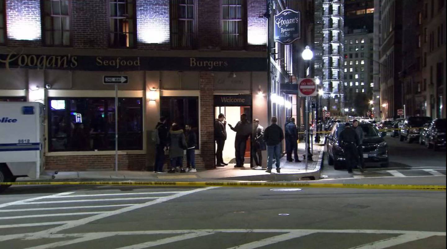 Police gather outside Coogan's bar on Milk Street in Boston Thursday night after a man sustained a serious head injury in a reported fight.