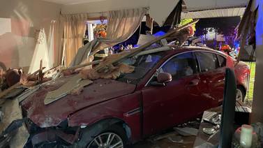 Two people hospitalized after car slams into occupied Swansea home