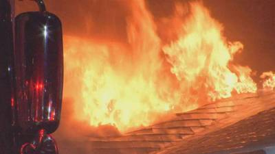 Firefighter falls through floor while battling blaze that tore through building in Arlington