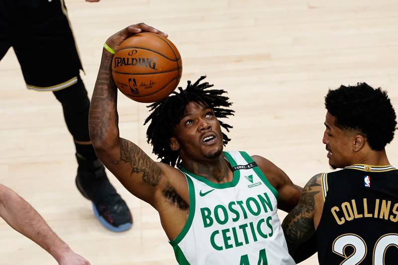 Boston Celtics center Robert Williams III works against Atlanta Hawks forward John Collins in the second half of an NBA basketball game Wednesday, Feb. 24, 2021, in Atlanta.