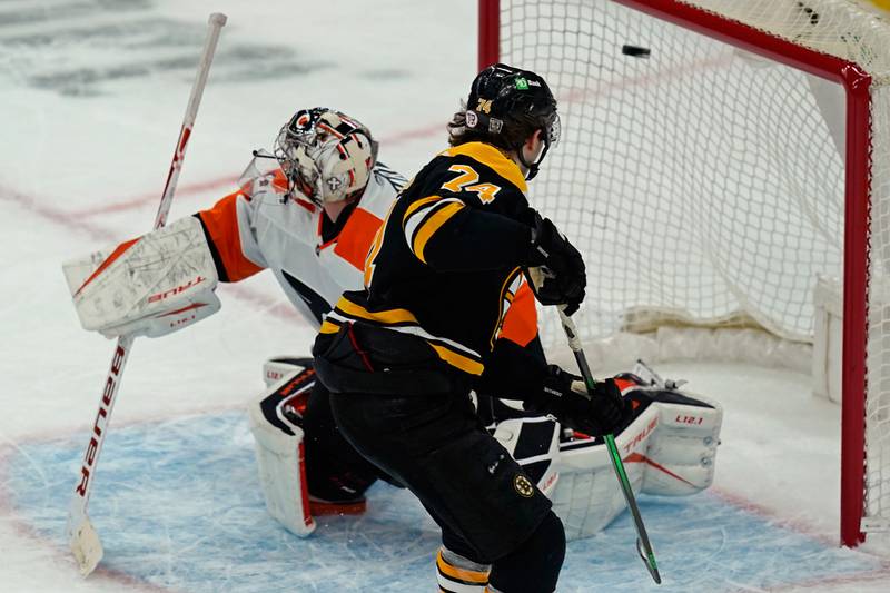 Boston Bruins left wing Jake DeBrusk scores against Philadelphia Flyers goaltender Carter Hart during a shootout Thursday, Jan. 21, 2021, in Boston. The Bruins won 5-4 in a shootout.