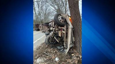 Driver cited, NH roadway closed for several hours after trash truck rollover
