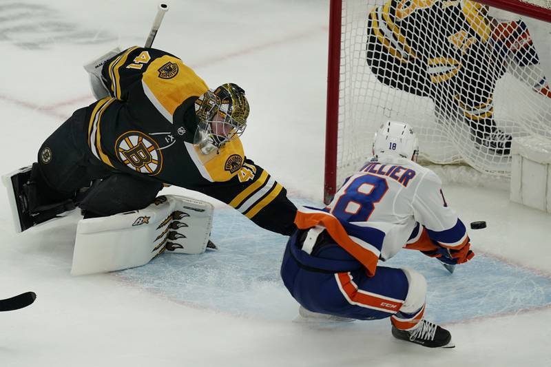 New York Islanders left wing Anthony Beauvillier scores the winning goal against Boston Bruins goaltender Jaroslav Halak in the overtime period of an NHL hockey game, Thursday, March 25, 2021, in Boston.