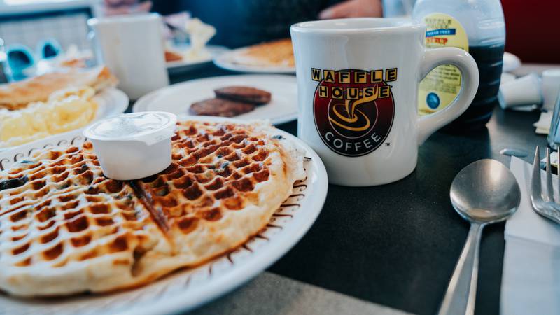 Breakfast meal at a Waffle House restaurant, serving breakfast all day. Focus on the coffee cup