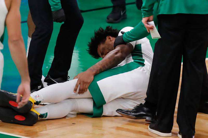 Boston Celtics' Marcus Smart grabs leg during the second half of an NBA basketball game against the Los Angeles Lakers, Saturday, Jan. 30, 2021, in Boston.