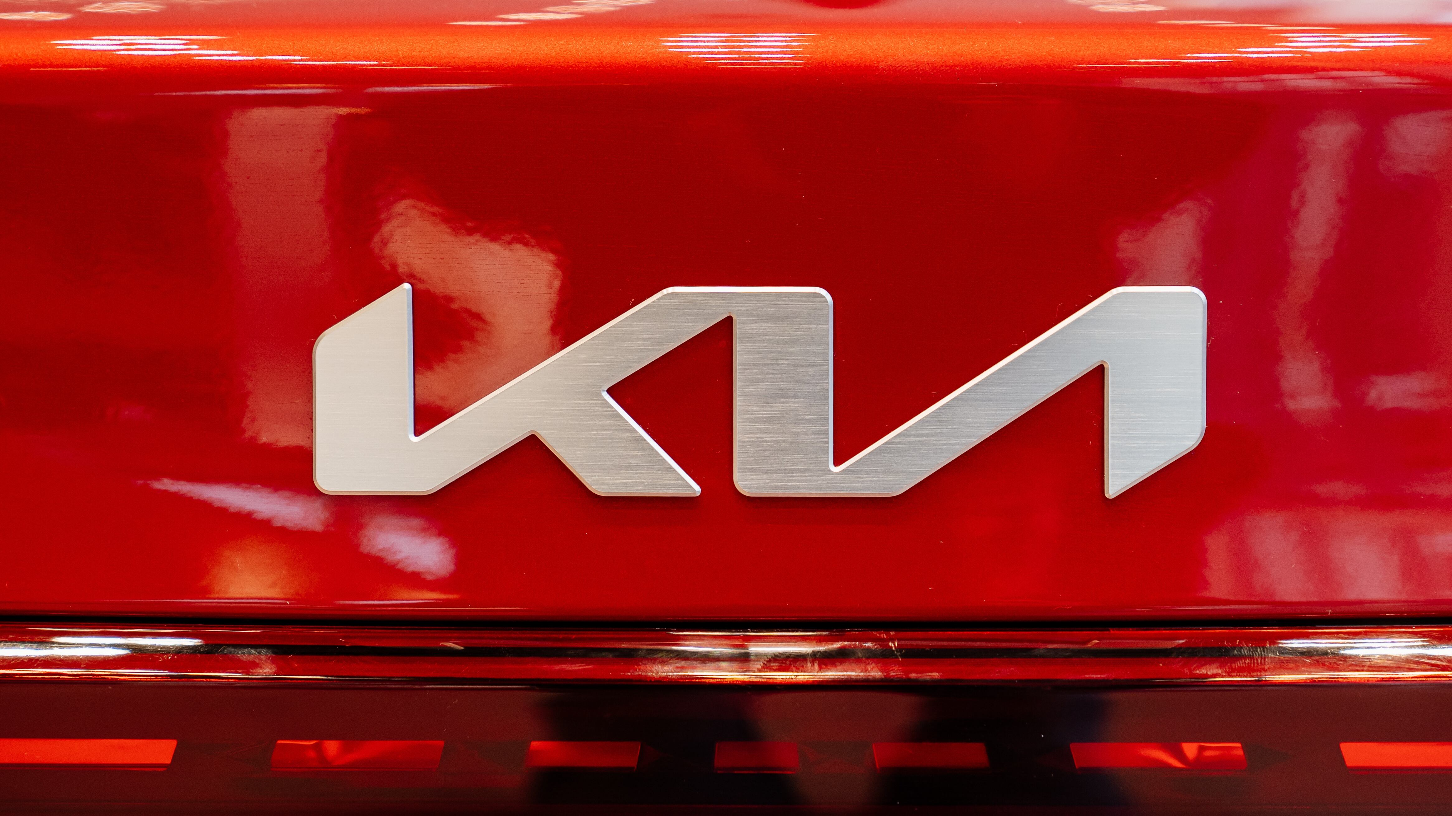 logo on the New red KIA car in the car dealership. rent, sale of cars at an authorized dealer.