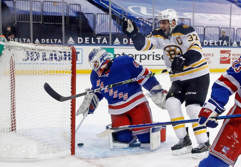 Boston Bruins' Patrice Bergeron celebrates the overtime goal by Bruins' Brad Marchand (not shown) against New York Rangers' Alexandar Georgiev in an NHL hockey game Wednesday, Feb. 10, 2021, in New York.