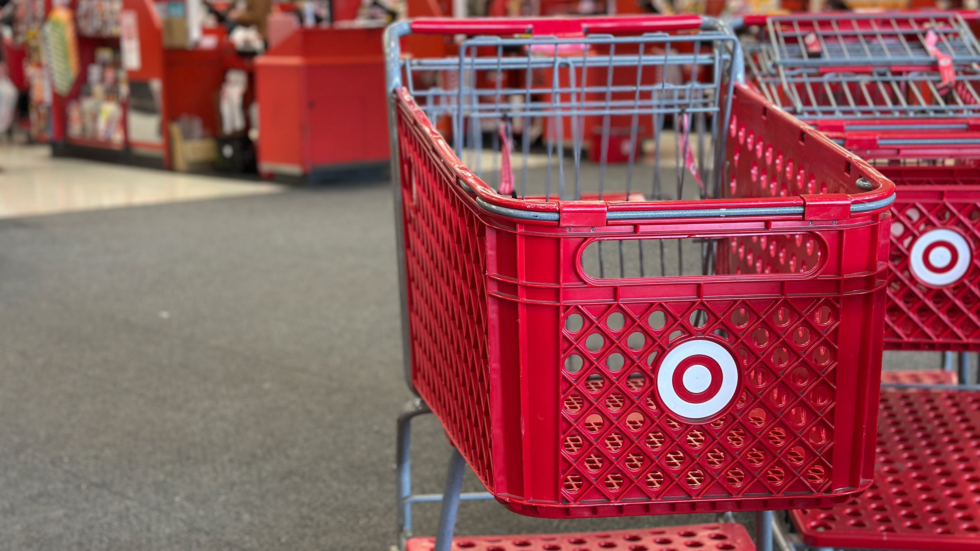 Red Target shopping cart inside a retail store.