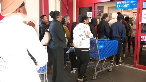 Families finished Thanksgiving dinner and stood in the cold waiting on the doors to open before sunset Thursday.