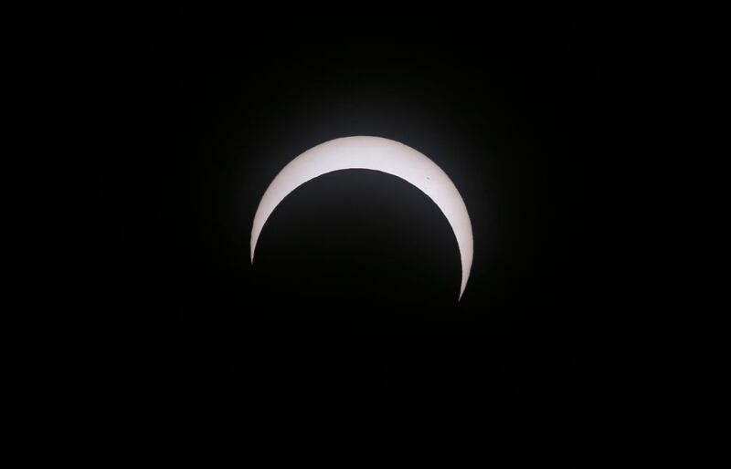 CAPITOL REEF NATIONAL PARK, UTAH - OCTOBER 14:  The moon crosses the sun as it exits the maximum eclipse during the Annular Solar Eclipse  on October 14, 2023 in Capitol Reef National Park, Utah. Starting at the Oregon coast and concluding on the east coast of South America an annular solar eclipse, where the moon is at its farthest from the Earth, will project a halo of sunlight around the moon's border.  (Photo by George Frey/Getty Images)