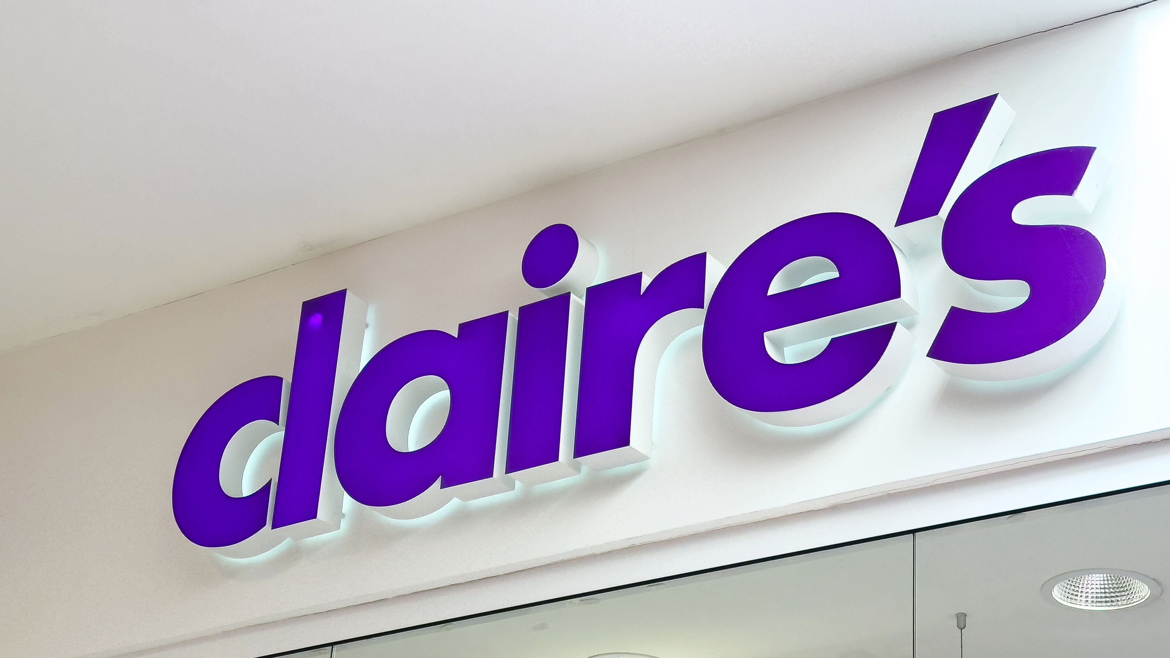 Claire's storefront signage display with bold purple logo on glass exterior.