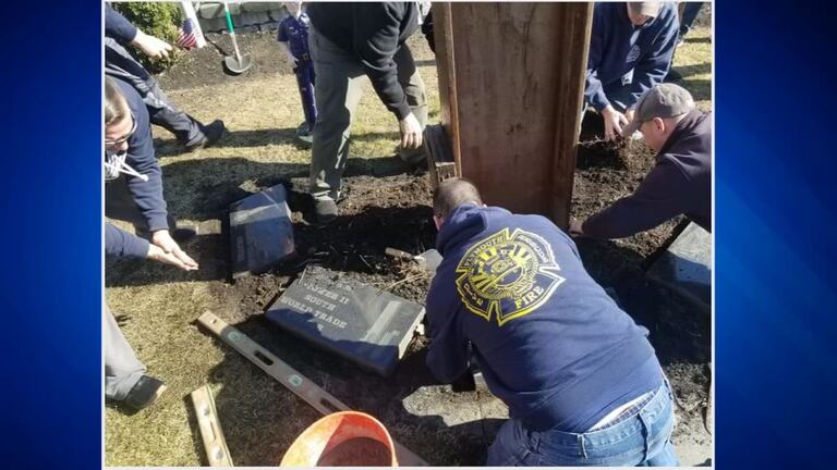 Nearly two dozen firefighters worked on Monday to make repairs to the vandalized memorial.