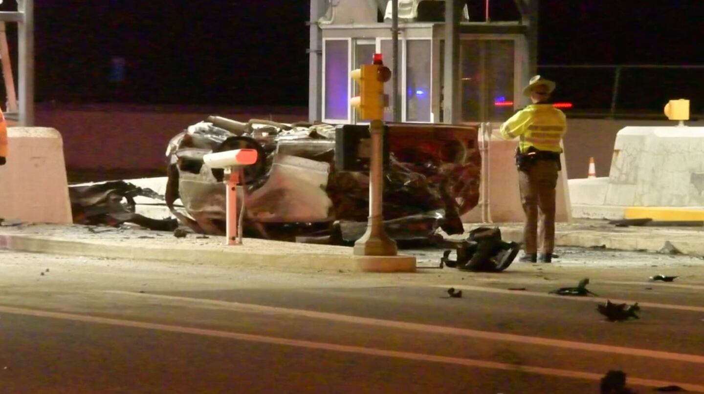 Police said the car caught fire after crashing into a toll booth that had an attendant inside. The attendant was not injured.