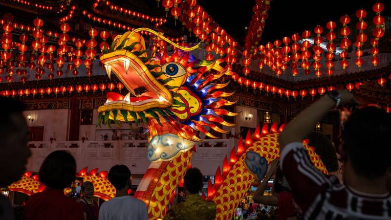 KUALA LUMPUR, MALAYSIA - FEBRUARY 09: People take picture with the decorative dragon lantern during a Lunar New Year celebration at Thean Hou Temple on February 09, 2024, in Kuala Lumpur, Malaysia. Chinese New Year in Malaysia is marked by family gatherings, festive adornments and traditional rituals embodying a spirit of hope and renewal for the year ahead, and aims to bring joy and prosperity to all while fostering a sense of unity and hope for a successful Year of the Dragon. (Photo by Annice Lyn/Getty Images)