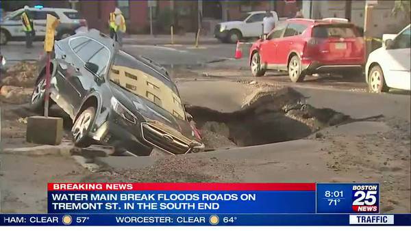 Road buckles and swallows car, homes flooded after water main break in Boston